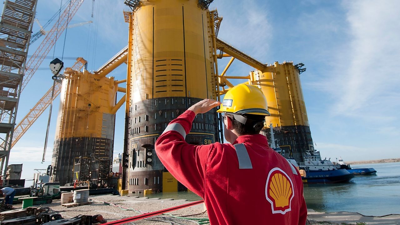 engineer in red uniform with yellow hard hat by marsb platform construction