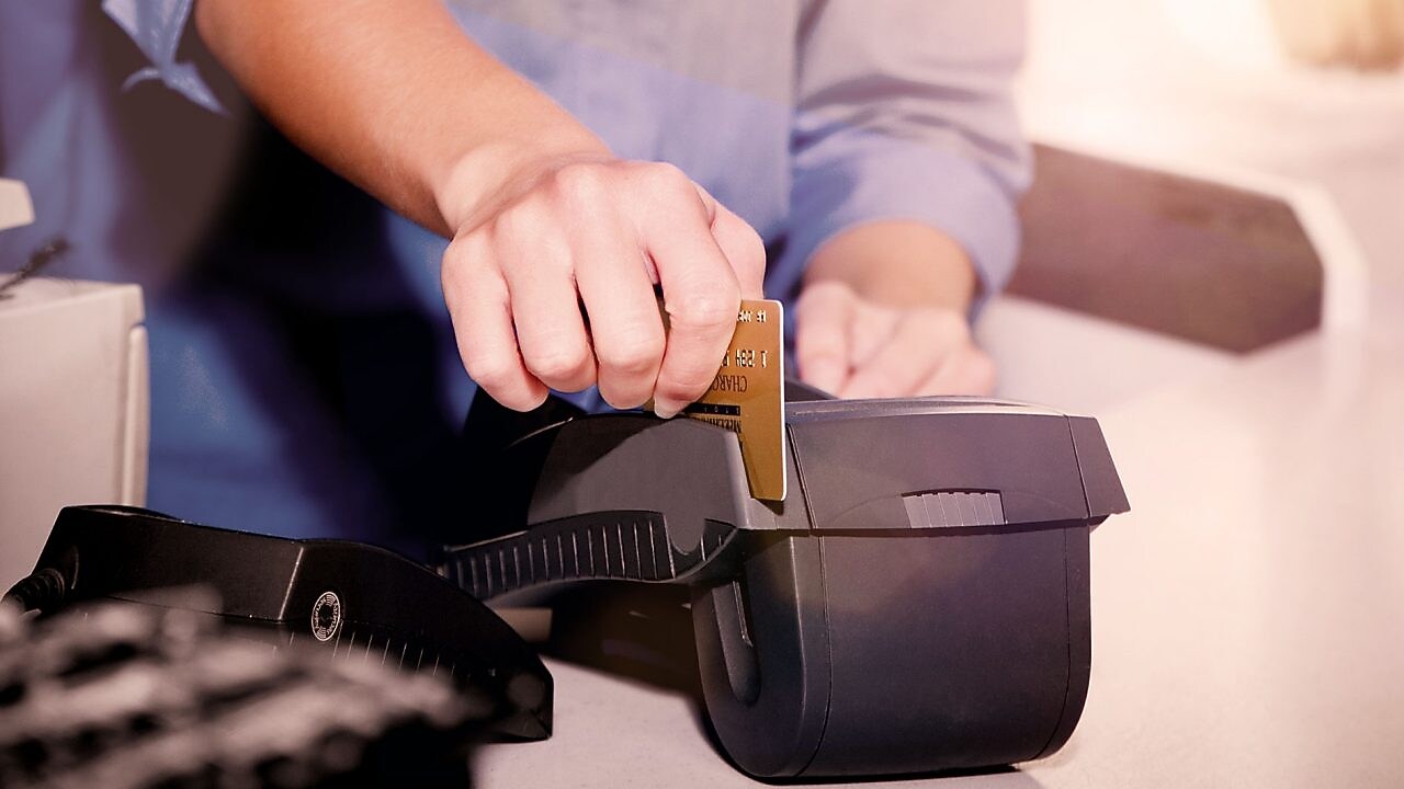 person swiping creditcard