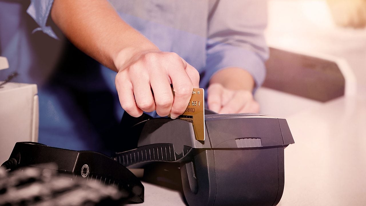 person swiping creditcard