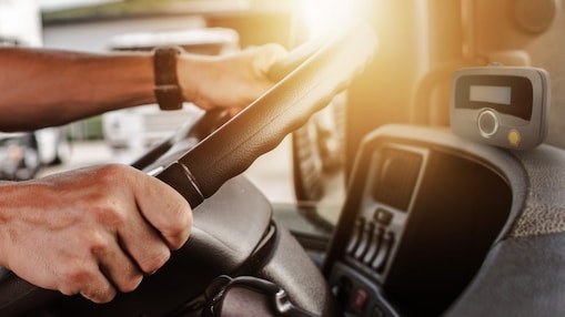 Hands control steering wheel and OBU on the board