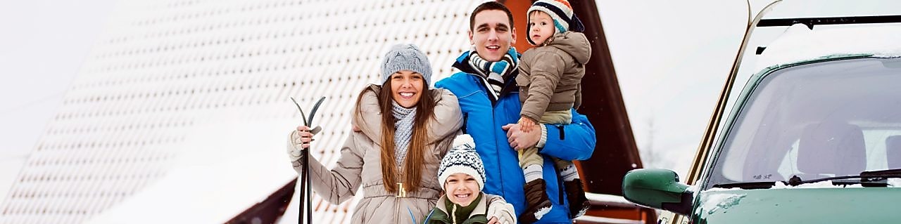 Femily besides their car during the winter season